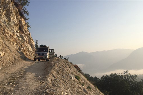 Jeep on narrow cliff-edge road