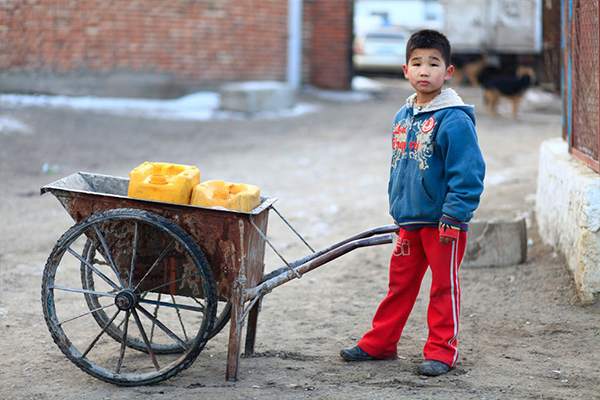 Mongolian child with wheelbarrow